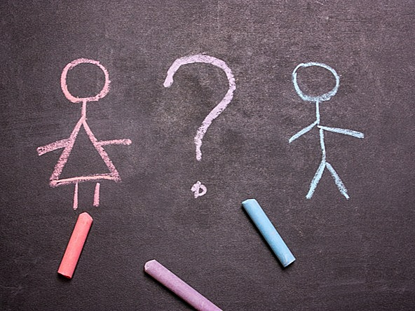 Chalk figures of a female and male in pink and blue respectively, with a question mark in between